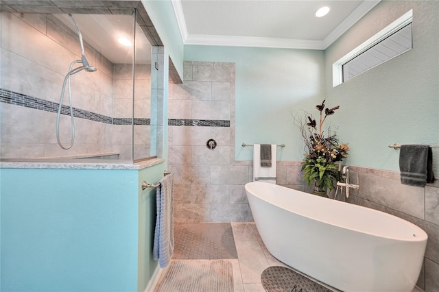 bathroom with tile walls, tile flooring, ornamental molding, and plus walk in shower