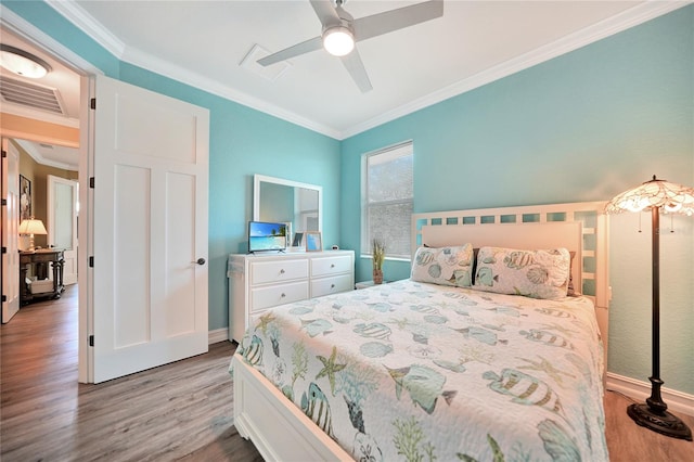 bedroom with ceiling fan, light hardwood / wood-style flooring, and crown molding