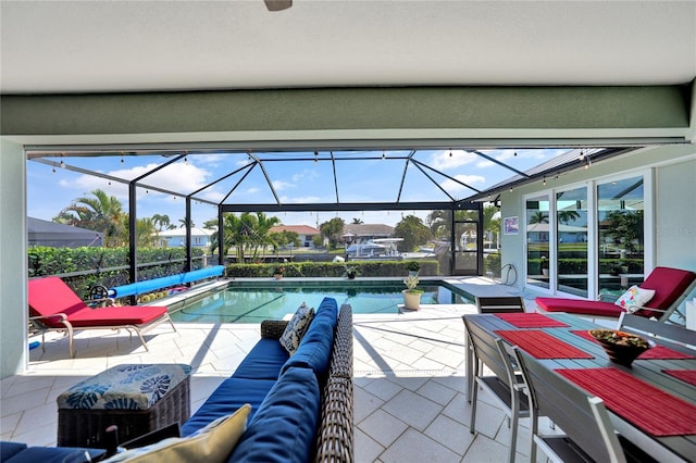 view of swimming pool with a patio area and a lanai