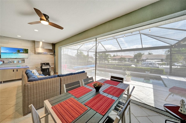 sunroom featuring ceiling fan