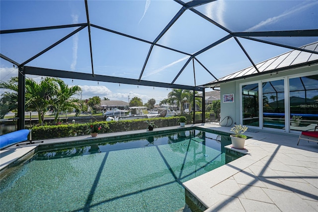 view of pool featuring glass enclosure and a patio