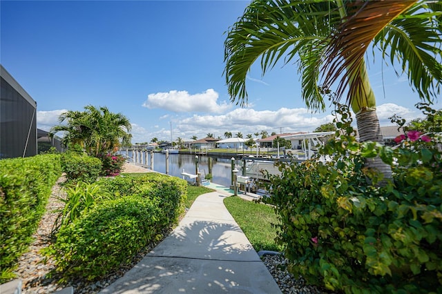 view of property's community featuring a water view and a boat dock