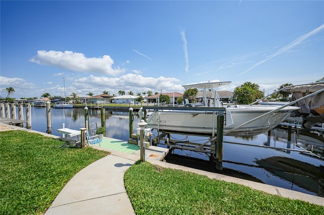 dock area featuring a lawn and a water view