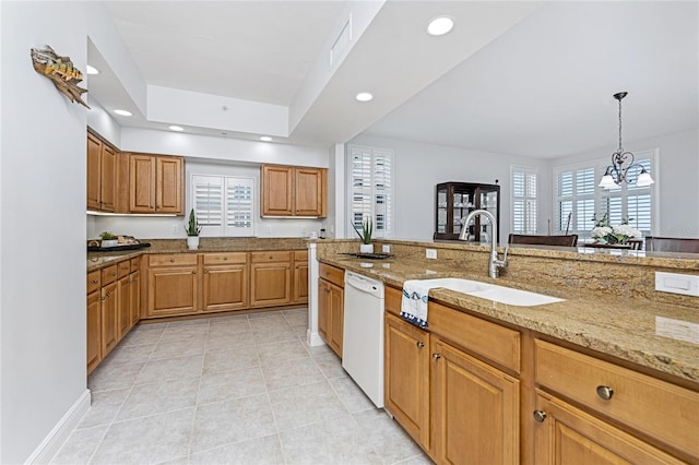 kitchen with a notable chandelier, white dishwasher, sink, light stone countertops, and decorative light fixtures