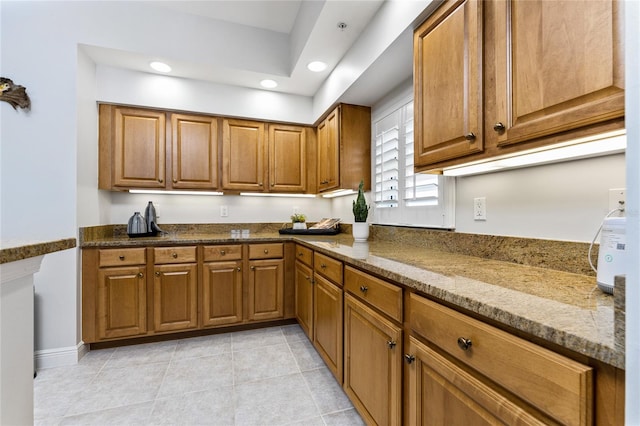 kitchen featuring stone counters and light tile patterned floors