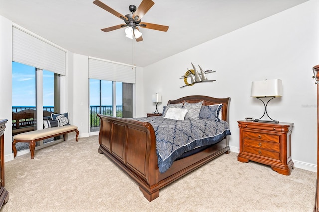 bedroom featuring light carpet, access to exterior, and ceiling fan