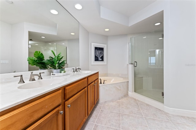 bathroom with tile patterned floors, vanity, and shower with separate bathtub