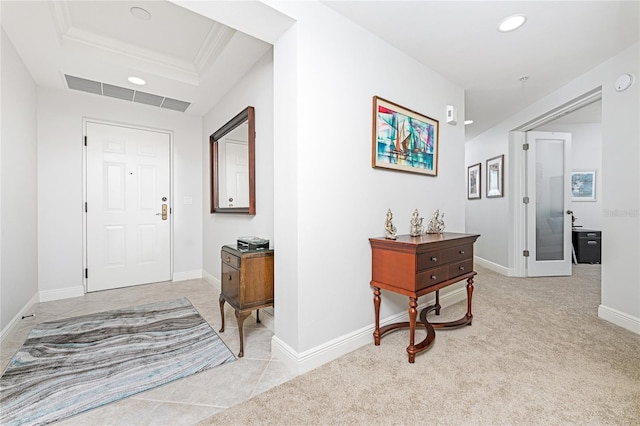 entryway with light colored carpet