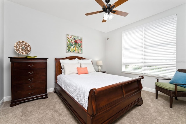 bedroom featuring ceiling fan and light carpet