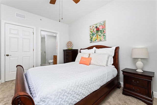 carpeted bedroom with ceiling fan and connected bathroom