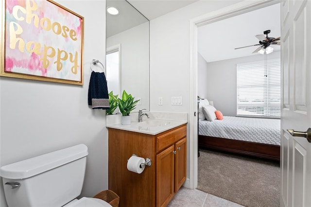 bathroom featuring tile patterned floors, vanity, toilet, and ceiling fan