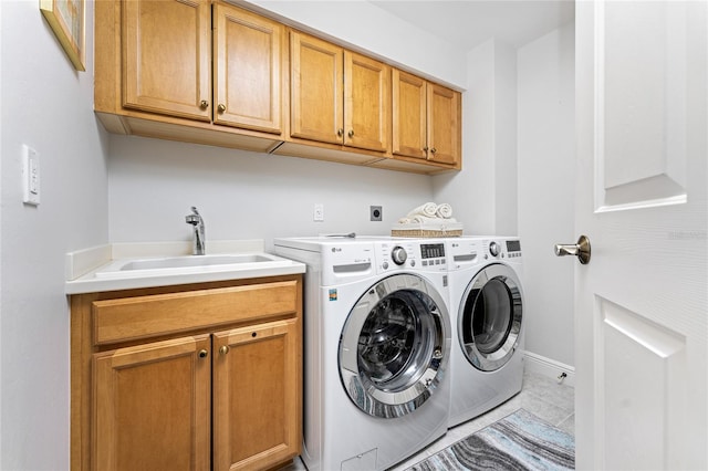 laundry room with washer and dryer, cabinets, light tile patterned floors, and sink