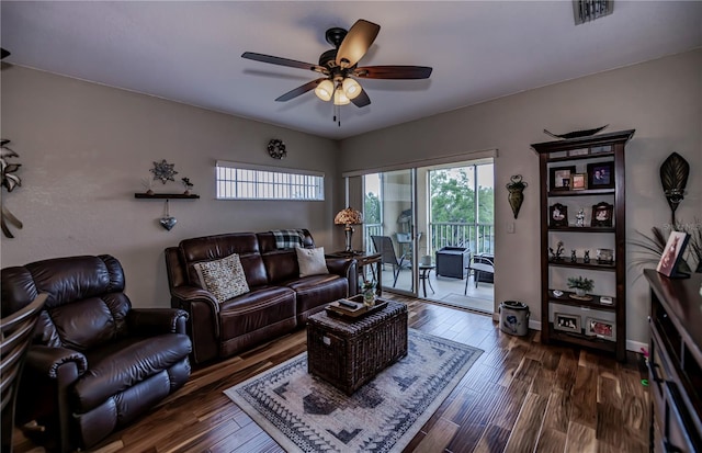 living room featuring dark hardwood / wood-style flooring and ceiling fan