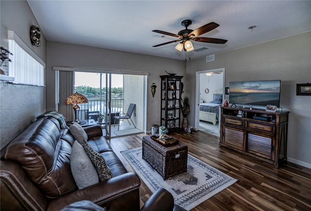 living room with dark hardwood / wood-style floors and ceiling fan