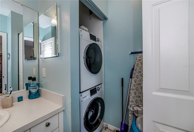 laundry area featuring stacked washer / dryer