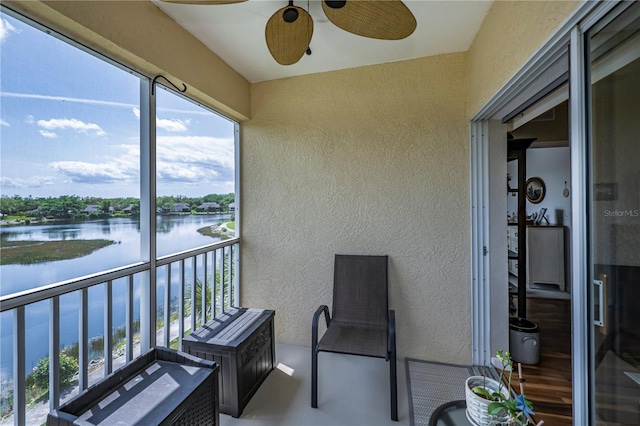 balcony featuring ceiling fan and a water view