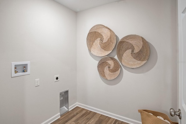 washroom with hookup for a washing machine, hookup for an electric dryer, and dark wood-type flooring