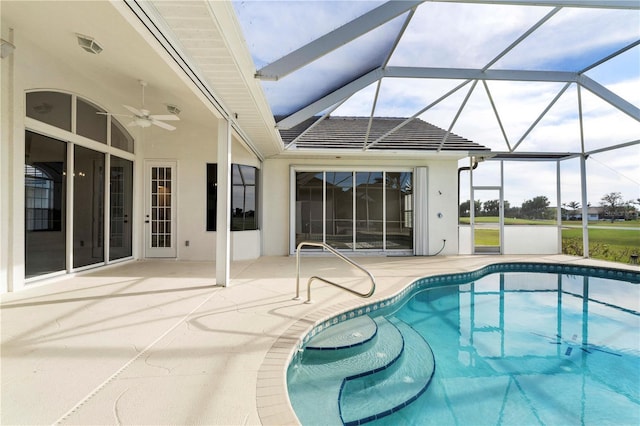 view of pool with a patio area, ceiling fan, and a lanai