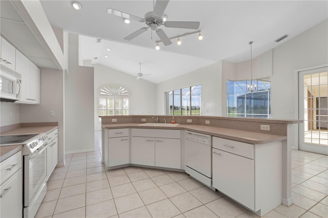 kitchen with ceiling fan with notable chandelier, white appliances, vaulted ceiling, sink, and white cabinetry