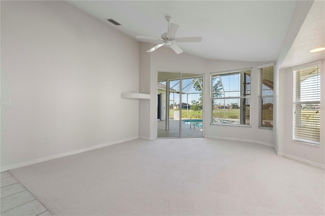 carpeted empty room with ceiling fan and vaulted ceiling