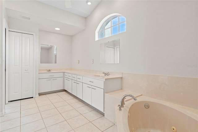 bathroom featuring tile patterned flooring, vanity, and a washtub