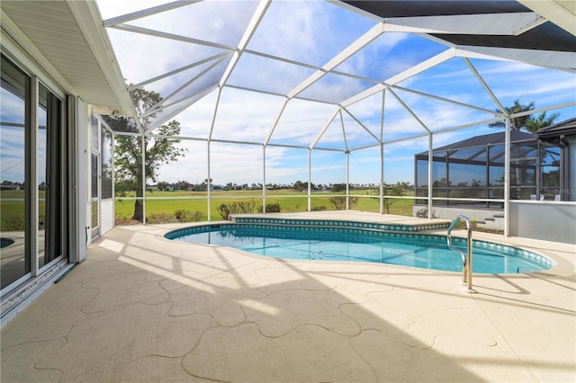 view of pool with glass enclosure and a patio area