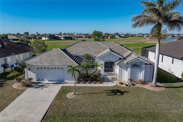 ranch-style home with a front yard and a garage