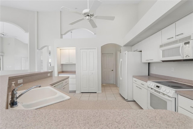 kitchen with white cabinets, white appliances, ceiling fan, and sink