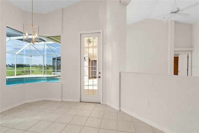 doorway with ceiling fan with notable chandelier, vaulted ceiling, and light tile patterned flooring