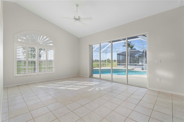 tiled spare room featuring ceiling fan, a healthy amount of sunlight, and vaulted ceiling