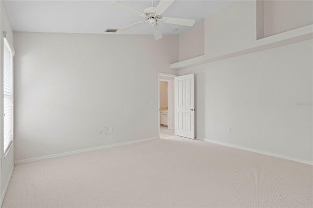 empty room featuring ceiling fan and light carpet