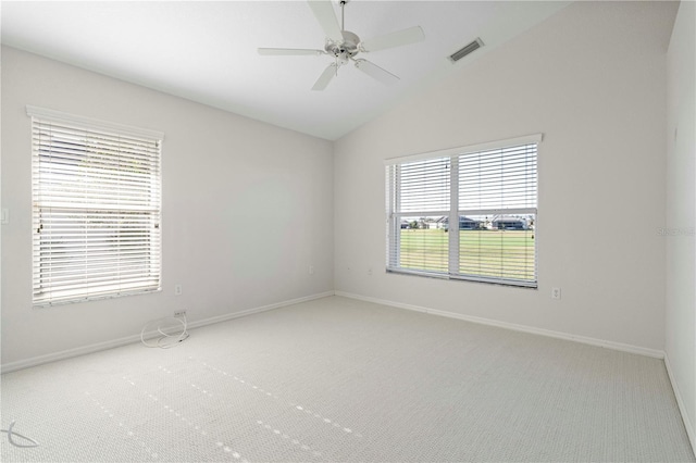 carpeted empty room featuring ceiling fan, a healthy amount of sunlight, and vaulted ceiling