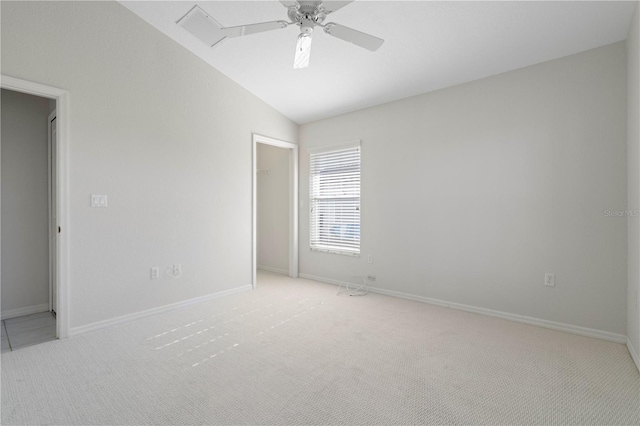 spare room with ceiling fan, light colored carpet, and lofted ceiling