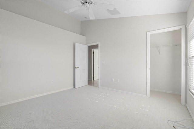 unfurnished bedroom featuring multiple windows, ceiling fan, a closet, and light colored carpet