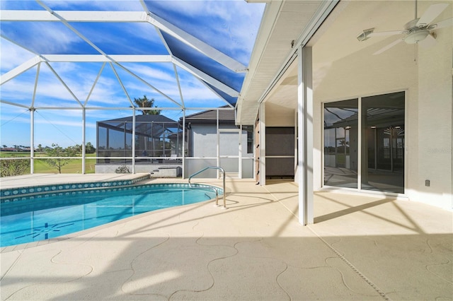 view of pool featuring a lanai, ceiling fan, and a patio