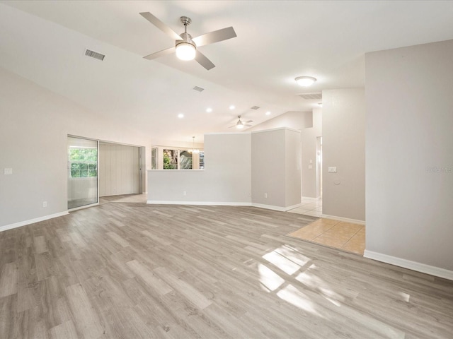 unfurnished room featuring lofted ceiling, light hardwood / wood-style floors, and ceiling fan