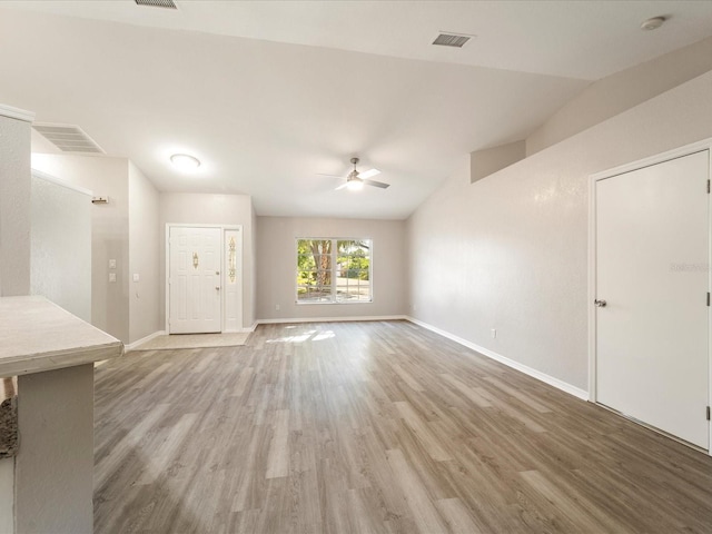 empty room featuring lofted ceiling, ceiling fan, and hardwood / wood-style flooring