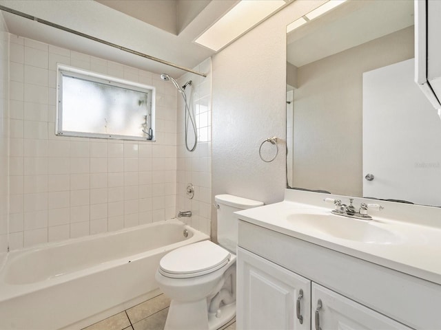 full bathroom featuring toilet, vanity, tiled shower / bath, and tile flooring