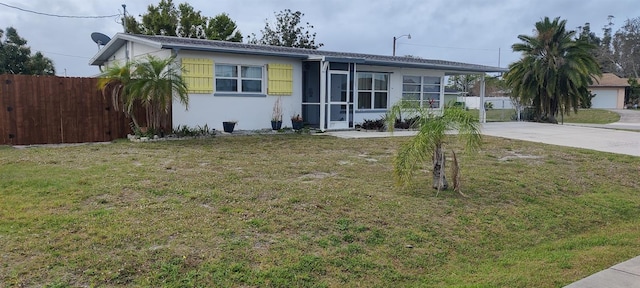 ranch-style home featuring a front lawn and a garage