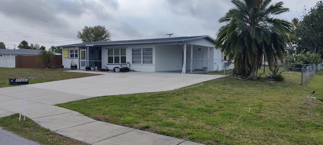 single story home featuring a carport and a front lawn