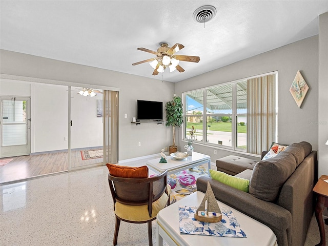 living room with hardwood / wood-style floors and ceiling fan