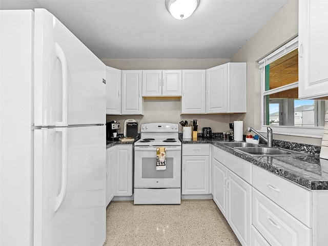 kitchen featuring white appliances, white cabinets, dark stone countertops, and sink