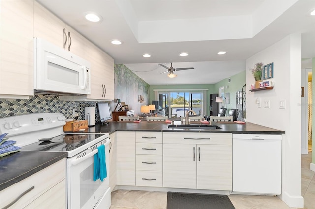 kitchen with kitchen peninsula, white appliances, ceiling fan, sink, and light tile patterned floors