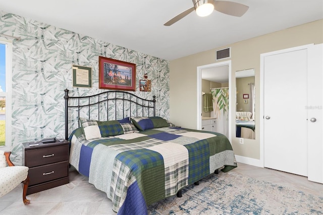 bedroom featuring ensuite bathroom and ceiling fan