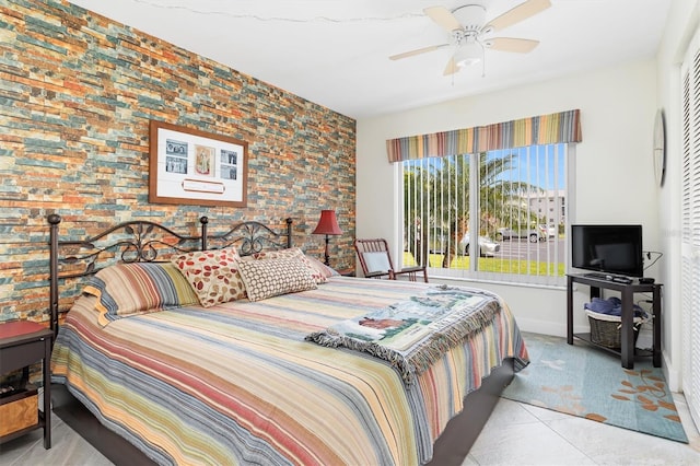 tiled bedroom featuring ceiling fan