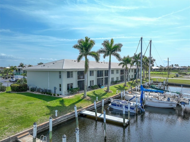 dock area with a water view and a lawn