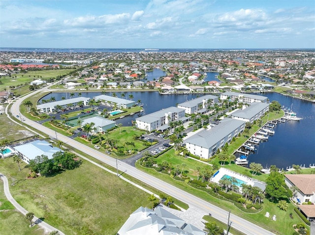 birds eye view of property with a water view and a residential view