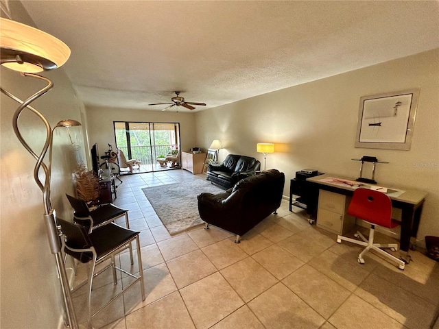 tiled living room with ceiling fan and a textured ceiling