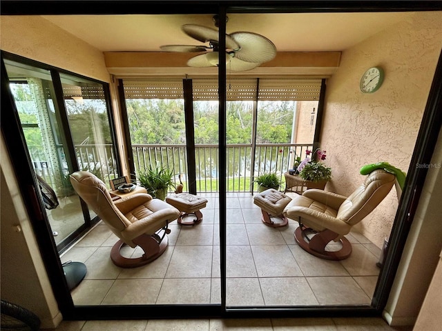 sunroom / solarium featuring ceiling fan