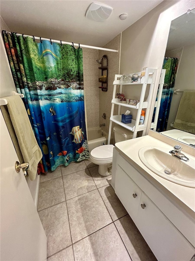 full bathroom featuring tile patterned floors, vanity, toilet, and shower / bath combo with shower curtain